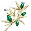 green stones brooch detail