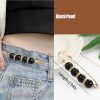 Gold brooch black nad crystals rings